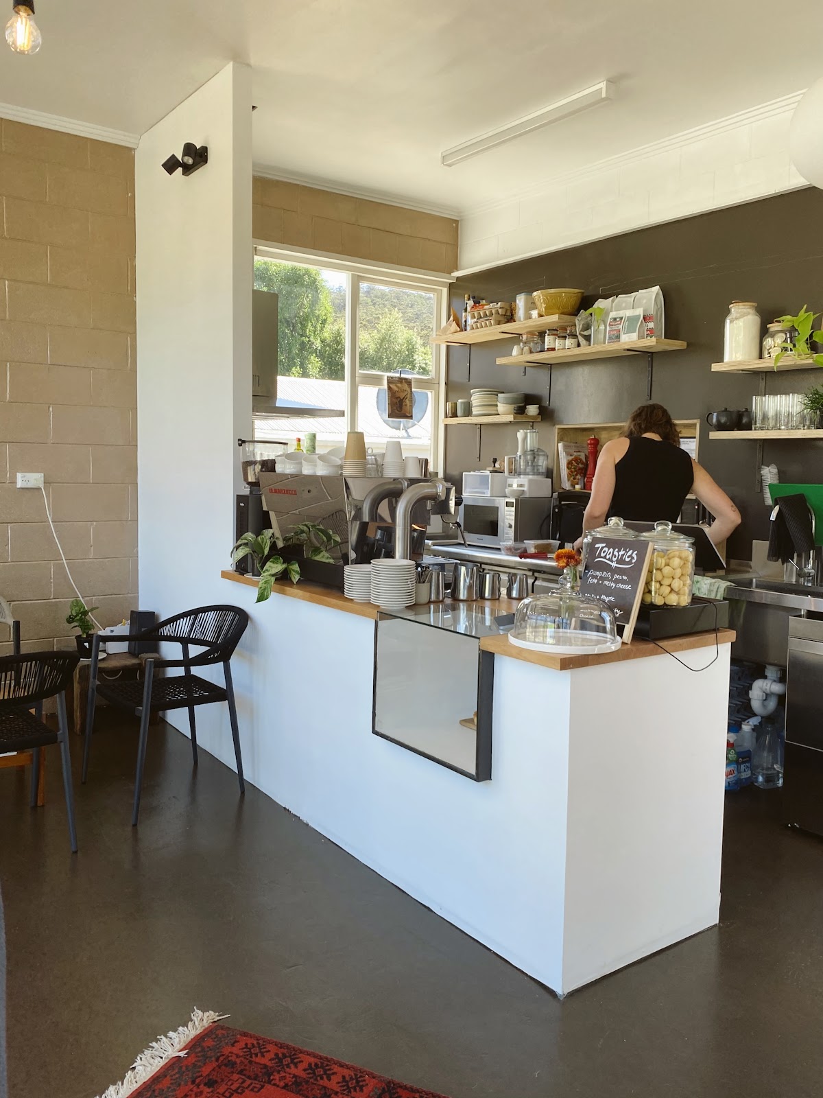 The Wild Bird counter with the espresso machine, timber shelves and the toasties blackboard