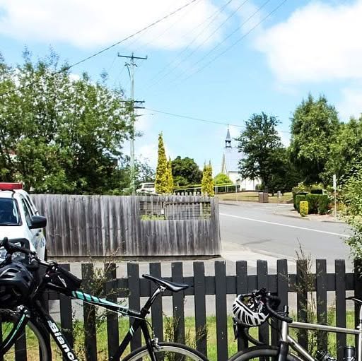 Road bikes leaning on the picket fence out the front